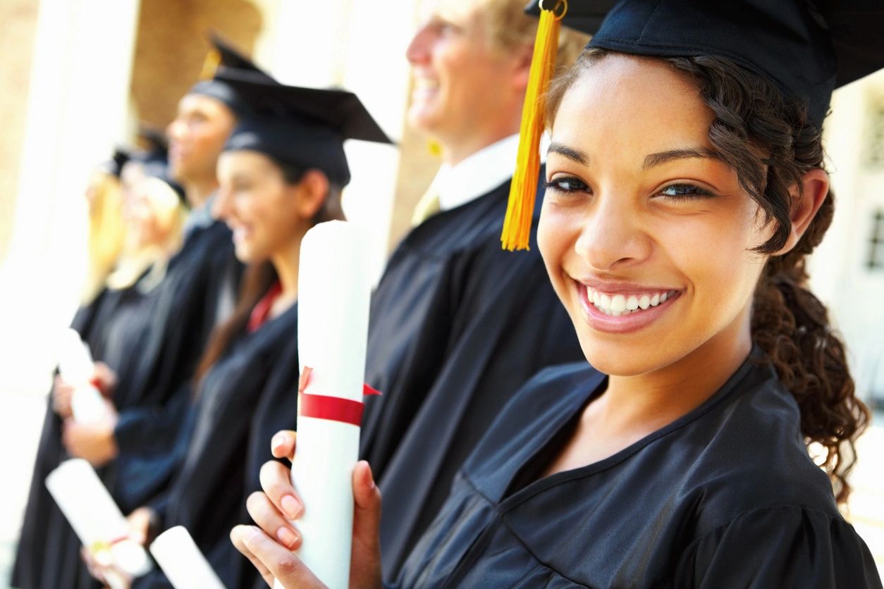 smiling student holding diploma